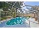 Inviting kidney-shaped pool with screened enclosure, providing a private oasis at 17721 Ridgeway Point Pl, Tampa, FL 33647