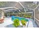 Inviting kidney-shaped pool with screened enclosure at 17721 Ridgeway Point Pl, Tampa, FL 33647