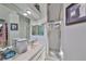 Clean bathroom with shower stall, vanity, and mirrored medicine cabinets at 17721 Ridgeway Point Pl, Tampa, FL 33647