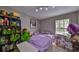 Bright bedroom with double bed, bookcase, and window overlooking the pool at 17721 Ridgeway Point Pl, Tampa, FL 33647