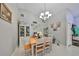 Cozy dining area with light wood table and charming wall decor at 17721 Ridgeway Point Pl, Tampa, FL 33647