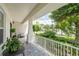 Covered front porch with seating and view of street at 8945 Bella Vita Cir, Land O Lakes, FL 34637