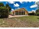 Back exterior view of the house with a large sunroom and patio at 5417 83Rd E Ter, Sarasota, FL 34243