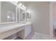 Bathroom with double vanity, white cabinets, and marble-look tile floor at 5417 83Rd E Ter, Sarasota, FL 34243