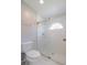 Bathroom with a toilet, shower, and a window for natural light at 5417 83Rd E Ter, Sarasota, FL 34243