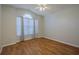 Bedroom with wood floors, ceiling fan, and arched window at 5417 83Rd E Ter, Sarasota, FL 34243