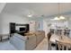 Open living room and kitchen with grey sectional sofa and dining area at 1015 Radison Lake Ct # 65, Sun City Center, FL 33573
