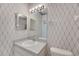 Bathroom with updated vanity and nautical-themed wallpaper at 1015 Radison Lake Ct # 65, Sun City Center, FL 33573
