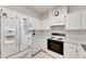 White kitchen with appliances and ample counter space at 1015 Radison Lake Ct # 65, Sun City Center, FL 33573