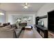 Open living room with sectional sofa, coffee table, and entertainment center at 1015 Radison Lake Ct # 65, Sun City Center, FL 33573