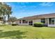 Spacious backyard with green lawn and a partially visible patio at 1015 Radison Lake Ct # 65, Sun City Center, FL 33573