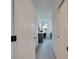 Bright hallway with carpeted floor, leading to a bedroom with a home office at 1015 Radison Lake Ct # 65, Sun City Center, FL 33573