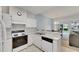 Kitchen features white cabinets, and overlooks dining and living areas at 1015 Radison Lake Ct # 65, Sun City Center, FL 33573