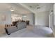 Open living space with grey sectional, access to kitchen and backyard at 1015 Radison Lake Ct # 65, Sun City Center, FL 33573
