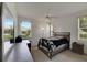 Bedroom with large windows and a queen bed at 1015 Radison Lake Ct # 65, Sun City Center, FL 33573