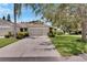 Two-car garage, well-maintained landscaping, and a spacious driveway at 1015 Radison Lake Ct # 65, Sun City Center, FL 33573