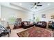 Cozy living room with comfortable seating and a large area rug at 8945 Bella Vita Cir, Land O Lakes, FL 34637