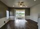 Bright living room with wood-look floors and sliding glass doors leading to a screened patio at 11074 Winter Crest Dr, Riverview, FL 33569