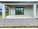 Covered back porch with sliding glass door and rock landscaping provides a tranquil outdoor space at 13292 Sea Bridge Dr, Hudson, FL 34669