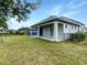 Spacious backyard with covered patio area, fenced perimeter, and green grass, ideal for outdoor gatherings at 13292 Sea Bridge Dr, Hudson, FL 34669