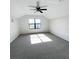 Bright bedroom features neutral walls, carpet, a ceiling fan, and a window bringing in natural light at 13292 Sea Bridge Dr, Hudson, FL 34669