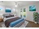 Relaxing bedroom featuring a queen bed, modern decor, and a sliding glass door to let in the natural light at 13292 Sea Bridge Dr, Hudson, FL 34669