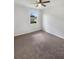 Bedroom featuring neutral carpeting and a window that allows for plenty of natural lighting at 13292 Sea Bridge Dr, Hudson, FL 34669