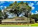 Lakeside entrance sign on a stone base beneath a beautiful shady tree and blue sky at 13292 Sea Bridge Dr, Hudson, FL 34669