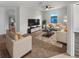 Bright living room with modern furniture, neutral tones, and a large flat screen television for relaxing and entertaining at 13292 Sea Bridge Dr, Hudson, FL 34669