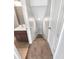 View of carpeted staircase leading down with a bathroom visible to the left and white door to the right at 13292 Sea Bridge Dr, Hudson, FL 34669