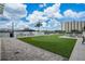 Rooftop putting green with outdoor grill and entertainment area against a blue sky at 2910 W Barcelona St # 1001, Tampa, FL 33629