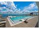 Rooftop pool featuring sleek lounge chairs and panoramic city views against cloudy skies at 2910 W Barcelona St # 1001, Tampa, FL 33629