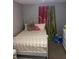 Bedroom with a white metal bed frame, colorful curtains, and toys at 6115 7Th Ave, New Port Richey, FL 34653
