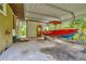 Carport with a boat on a trailer parked next to the storage garage at 7242 Alafia Ridge Loop, Riverview, FL 33569