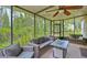 Relaxing screened porch with wicker furniture and a fire pit at 26638 Green Willow Run, Wesley Chapel, FL 33544