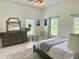 Large bedroom with plush carpet, big windows, dresser and comfy bed at 26638 Green Willow Run, Wesley Chapel, FL 33544