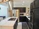Contemporary kitchen with dark cabinetry and a large island at 26638 Green Willow Run, Wesley Chapel, FL 33544
