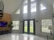 Spacious living room with large windows, high ceilings and a spiral staircase at 26638 Green Willow Run, Wesley Chapel, FL 33544