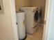 Bright laundry room with washer, dryer, and water heater at 26638 Green Willow Run, Wesley Chapel, FL 33544