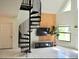 Modern spiral staircase leading to the upper level of the home at 26638 Green Willow Run, Wesley Chapel, FL 33544