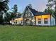 A-frame style home with a stone facade and charming front yard at 26638 Green Willow Run, Wesley Chapel, FL 33544