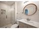 Clean bathroom with a large mirror and tiled shower at 1837 Worrington St, Sarasota, FL 34231