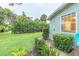 Landscaped side yard with a grassy area and flowers at 1837 Worrington St, Sarasota, FL 34231