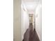 Long hallway with dark hardwood floors and white walls at 1837 Worrington St, Sarasota, FL 34231