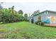 Spacious backyard with a wooden deck and privacy hedge at 1837 Worrington St, Sarasota, FL 34231