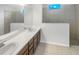 Bathroom features a double vanity, shower, and tile flooring at 13292 Sea Bridge Dr, Hudson, FL 34669