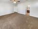 Large bedroom with ceiling fan and carpet flooring at 13292 Sea Bridge Dr, Hudson, FL 34669