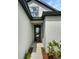 Modern black front door with glass panel at 13292 Sea Bridge Dr, Hudson, FL 34669