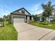 Two story home with gray siding and two car garage at 13292 Sea Bridge Dr, Hudson, FL 34669