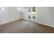 Bright bedroom with neutral carpeting and double doors to patio at 13292 Sea Bridge Dr, Hudson, FL 34669